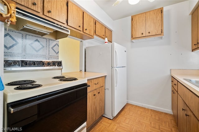 kitchen featuring white appliances, custom exhaust hood, and light parquet flooring