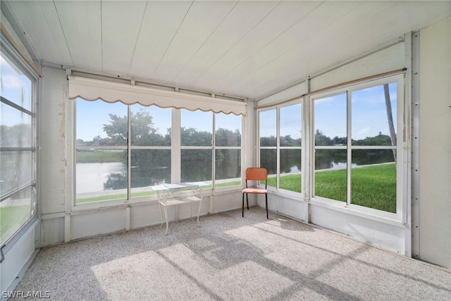 unfurnished sunroom with a water view