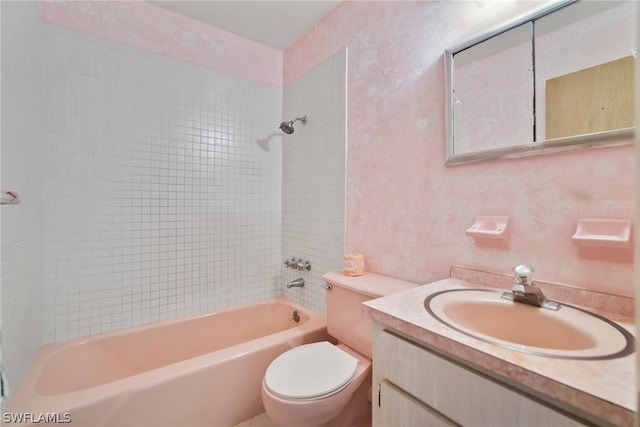 full bathroom with vanity, toilet, and tiled shower / bath combo