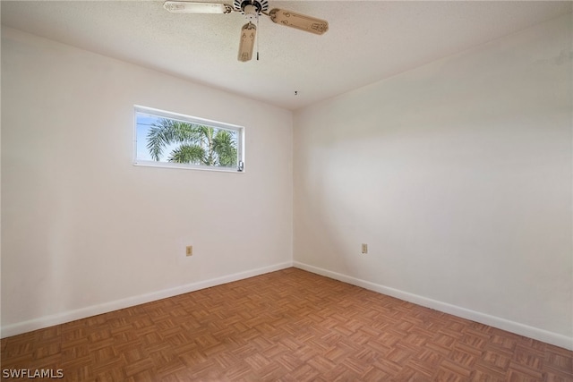 unfurnished room featuring ceiling fan, a textured ceiling, and parquet floors