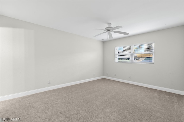 carpeted empty room featuring ceiling fan