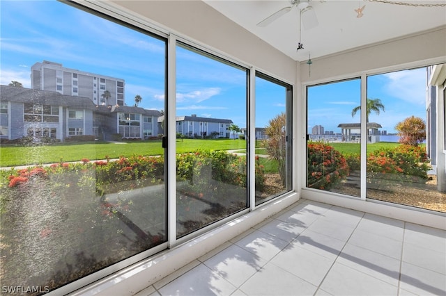 unfurnished sunroom featuring a wealth of natural light and ceiling fan