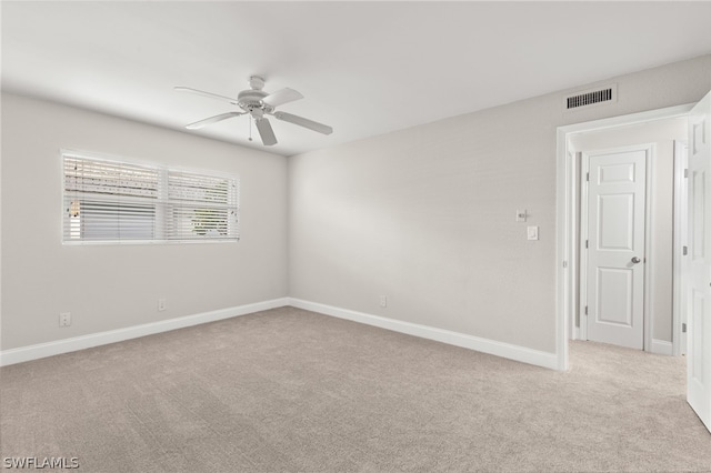 carpeted empty room featuring ceiling fan