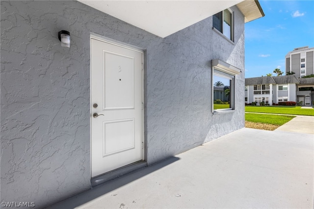 doorway to property featuring a yard