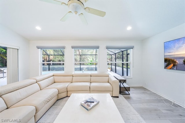 living room featuring light hardwood / wood-style floors and ceiling fan