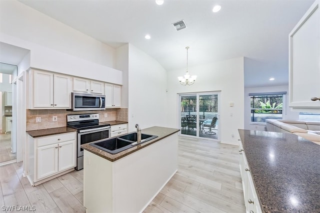 kitchen featuring stainless steel appliances, sink, backsplash, and white cabinets