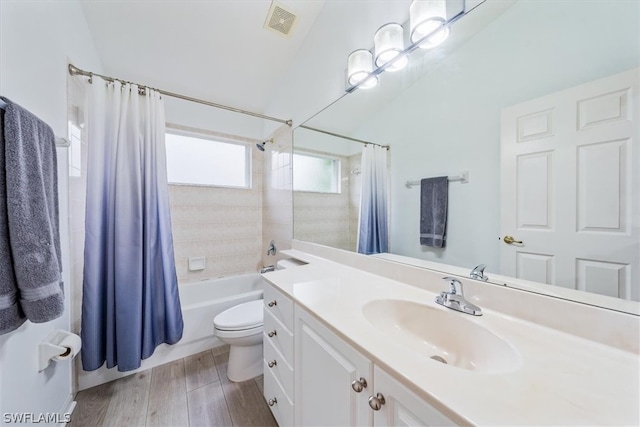 full bathroom featuring shower / bath combo, oversized vanity, and toilet