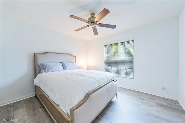 bedroom featuring hardwood / wood-style flooring and ceiling fan