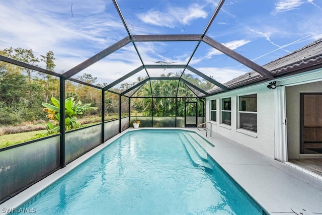 view of swimming pool with glass enclosure