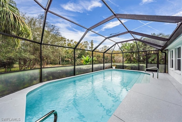 view of pool featuring a patio area and glass enclosure