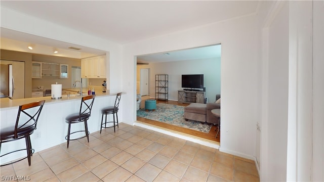 living room with light tile patterned flooring and sink