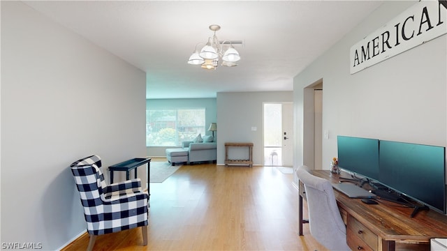 interior space featuring a chandelier and light wood-type flooring