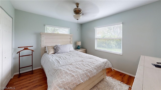 bedroom featuring ceiling fan, a closet, and dark hardwood / wood-style floors