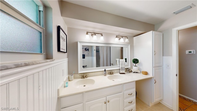 bathroom with tile patterned flooring, vanity, and plenty of natural light