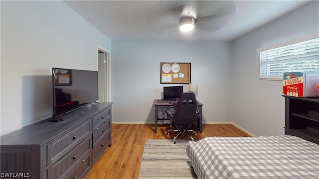 bedroom with ceiling fan and light hardwood / wood-style floors