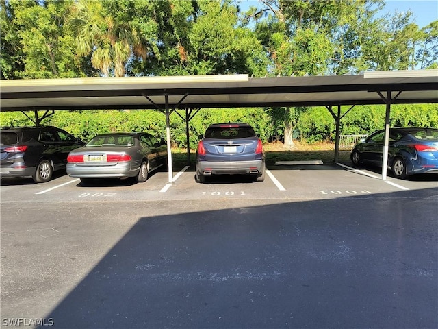 view of vehicle parking with a carport