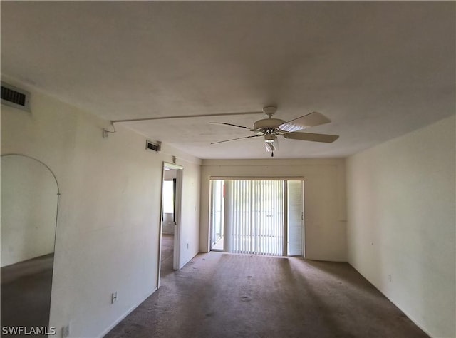 carpeted spare room featuring ceiling fan