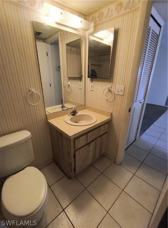 bathroom featuring tile patterned floors, vanity, and toilet