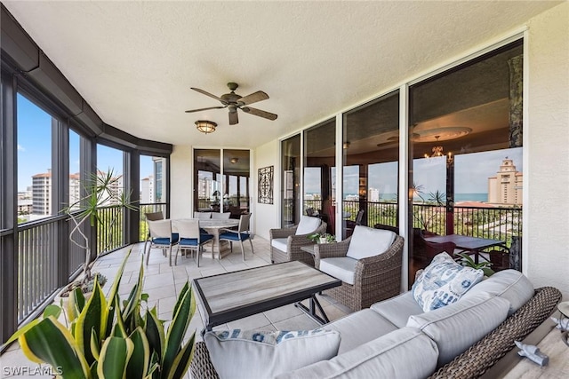 sunroom featuring ceiling fan