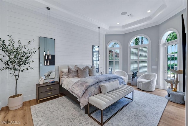 bedroom with access to outside, ornamental molding, wood finished floors, and visible vents