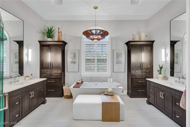 full bathroom featuring a bathtub, two vanities, a sink, and ornamental molding