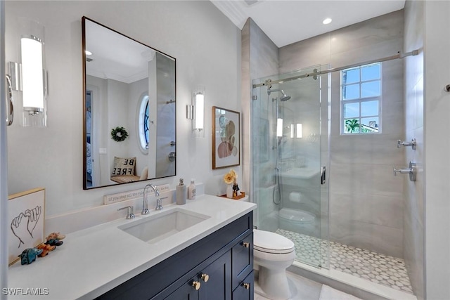 full bathroom with a shower stall, toilet, and vanity