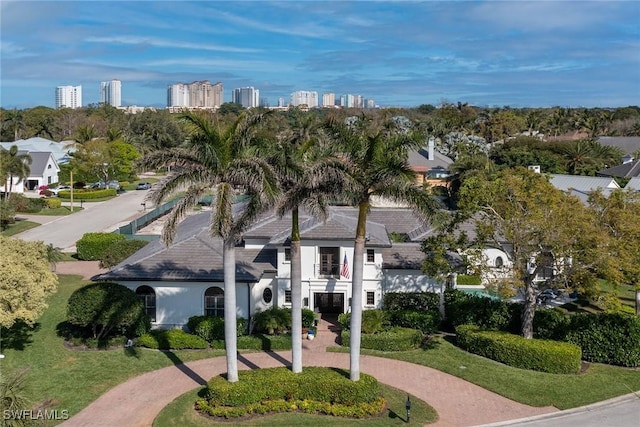 view of property's community with decorative driveway and a city view