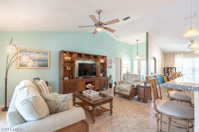 living room featuring light tile patterned floors, french doors, vaulted ceiling, and ceiling fan