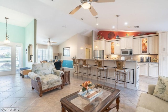 living room with light tile patterned floors, high vaulted ceiling, and ceiling fan