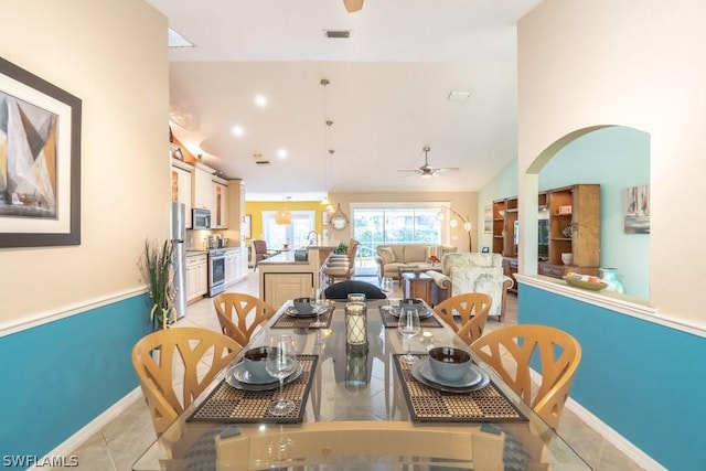 tiled dining area with ceiling fan