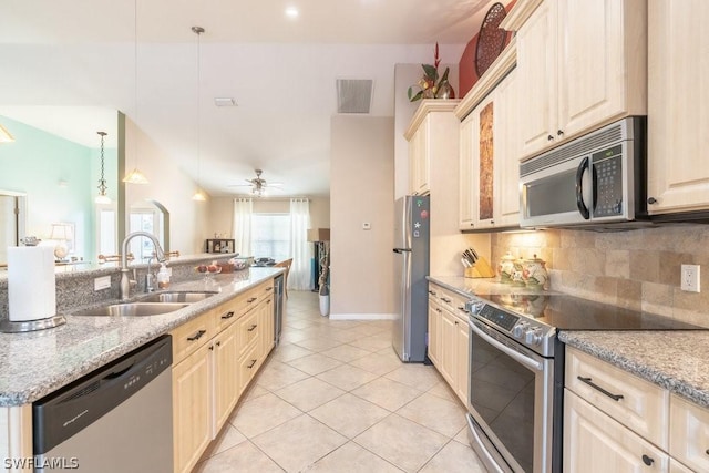 kitchen featuring light stone counters, stainless steel appliances, ceiling fan, light tile patterned floors, and hanging light fixtures