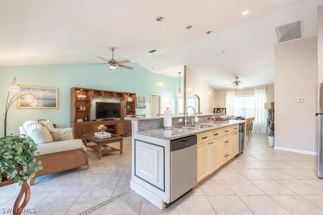 kitchen with appliances with stainless steel finishes, sink, pendant lighting, lofted ceiling, and an island with sink