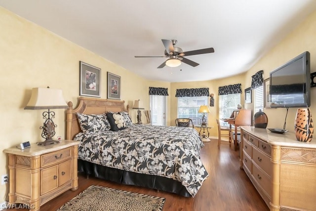 bedroom with dark hardwood / wood-style flooring and ceiling fan