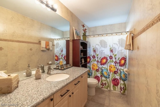 full bathroom featuring vanity, shower / bath combination with curtain, toilet, and tile walls