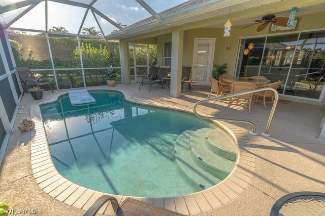 view of swimming pool with glass enclosure, ceiling fan, and a patio