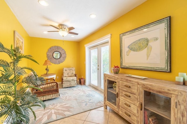 sitting room with ceiling fan and light tile patterned flooring