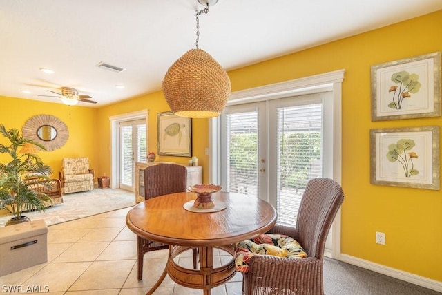 tiled dining room featuring french doors and ceiling fan