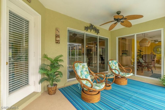 sunroom / solarium featuring ceiling fan