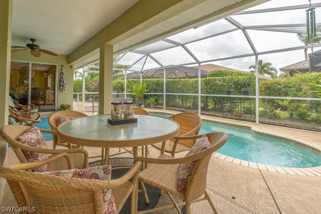 view of pool featuring a patio, ceiling fan, and a lanai