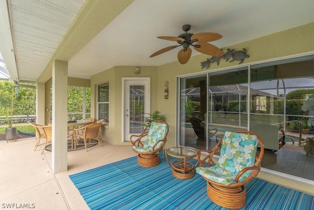 view of patio / terrace with ceiling fan and a lanai