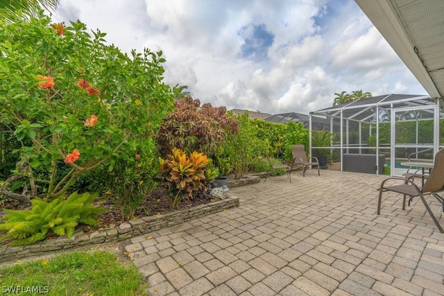 view of patio / terrace featuring a lanai