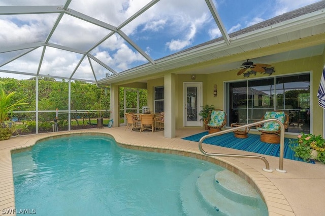 view of swimming pool featuring a lanai, ceiling fan, and a patio area