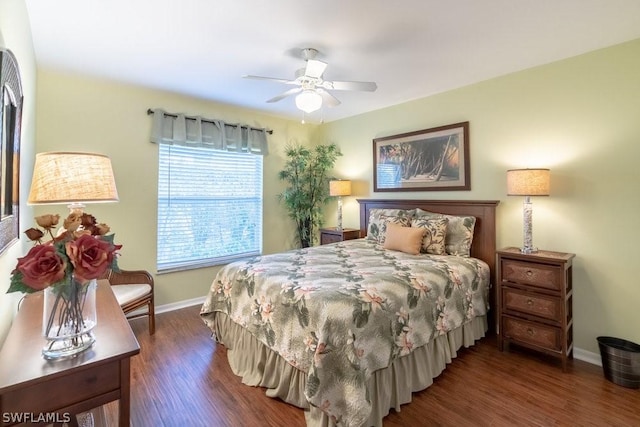 bedroom with dark hardwood / wood-style flooring and ceiling fan