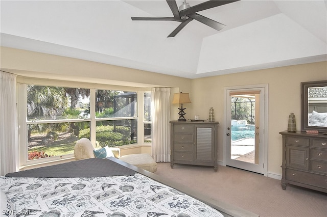 carpeted bedroom featuring access to outside, ceiling fan, and a tray ceiling