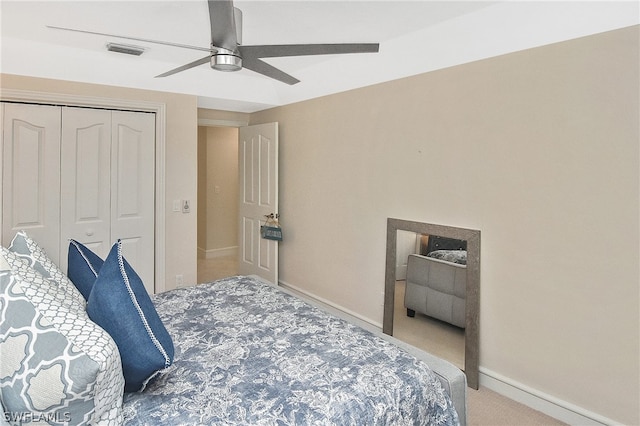 bedroom with carpet, ceiling fan, and a closet