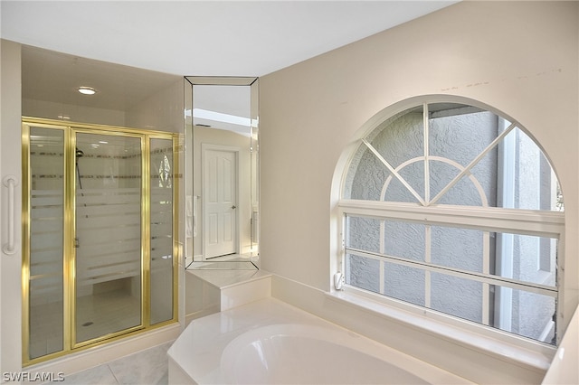 bathroom with tile patterned flooring, separate shower and tub, and a healthy amount of sunlight