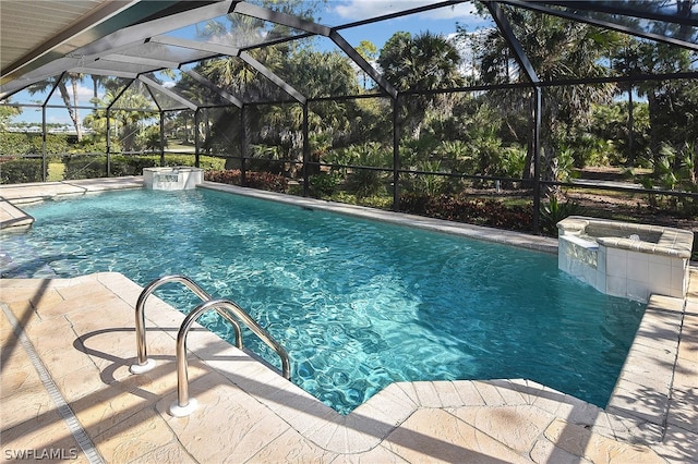 view of swimming pool with pool water feature, a patio area, and a lanai