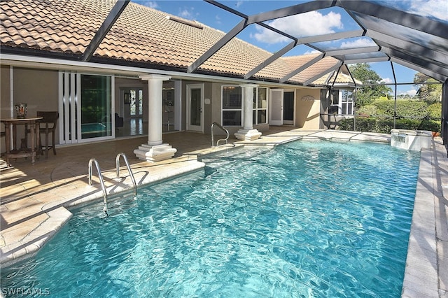 view of pool with a lanai and a patio