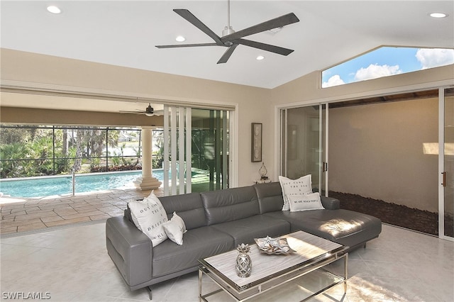 living room featuring ceiling fan and lofted ceiling