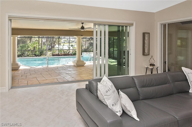 tiled living room featuring ceiling fan